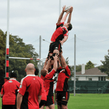 A group of people playing a game of rugby with KIWI DESIGN jerseys on and utilizing R80 Aerial Support - Lifting Blocks for R80 Rugby.