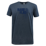 Introducing the Raise the Flag Supersoft Tee by WRS LAT—a blue, supersoft shirt adorned with a dark blue graphic of an American flag and the text "RAISE THE FLAG" on the chest. This tee is perfect for any patriotic USA team apparel collection.