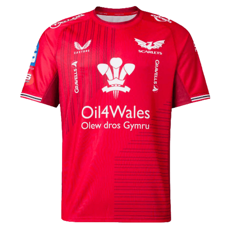 The Scarlets Replica Home Jersey 23/24 by Castore features a red sports jersey design with the "Scarlets," "Oil4Wales," and "Olew dros Gymru" logos accompanied by various smaller logos. This Athletic Fit jersey is an essential addition for any Welsh rugby union supporter.