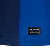 Close-up of a blue fabric with a black rectangular label featuring "CASTORE" and the number "104922448" in white text, showcasing its athletic fit. An ideal choice for those looking for a stylish Leinster 24/25 Replica Home Jersey by Castore.