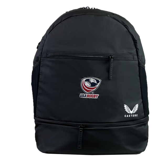 The USA Rugby Backpack by Castore has ergonomic shoulder straps for comfort, a sleek black design, and features the iconic USA Rugby logo and Castore branding in white on the front pocket.