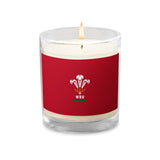 The PF LIC Wales Rugby Soy Wax Candle comes in a clear glass container with a red label showcasing the Welsh Rugby Union logo, making it an ideal addition to any rugby fan's collection.