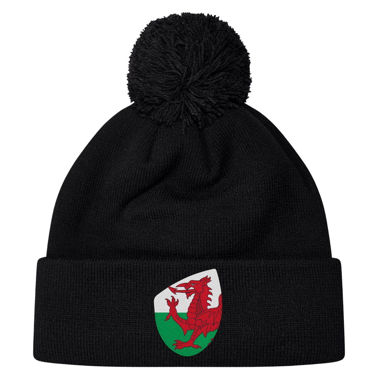 The EMB Canterbury Wales Shield Pom Pom Beanie is a stylish black beanie with a striking patch featuring a red dragon against a green and white backdrop, reminiscent of the Wales Shield.