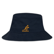 EMB Alpha Broder Wallabies Rugby Crusher Bucket Hat in navy blue, features an orange stylized kangaroo logo with the text "Wallabies" underneath, and is crafted from cotton twill for optimal sun protection.