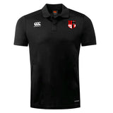 The Amoskeag Rugby Club Dry Polo by EMB Canterbury is a black collared polo featuring the Canterbury logo on the right chest and a red and white shield emblem on the left. It includes Vapodri Technology for breathability and quick drying, ensuring optimal comfort.