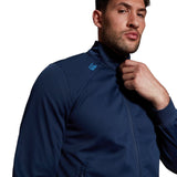 Man in a Canterbury Elite Windstopper Jacket adjusting the collar, cropped close-up focusing on the upper body and face for a comfortable fit.