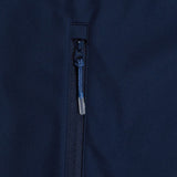 Close-up of a dark blue zipper partially closed on a garment with a navy fabric background, featuring weatherproofing elements of the Canterbury Elite Windstopper Jacket.