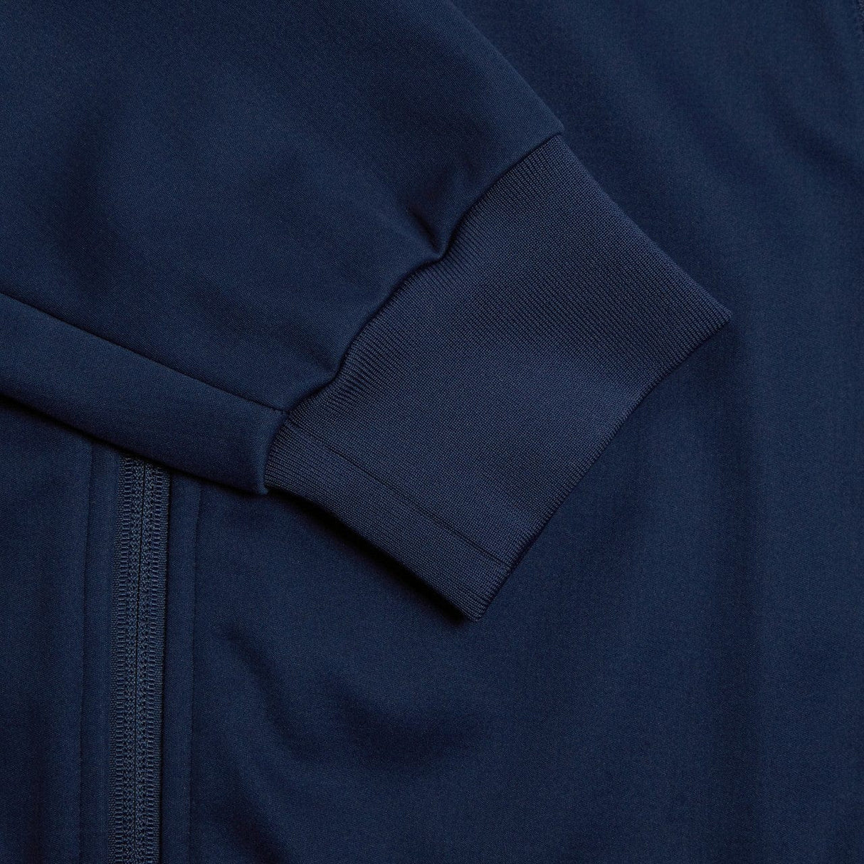 Close-up of the Canterbury Elite Windstopper Jacket in navy blue, with detailed stitching showing the texture of the fabric and a zipper.