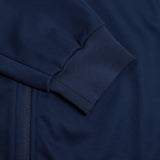 Close-up of the Canterbury Elite Windstopper Jacket in navy blue, with detailed stitching showing the texture of the fabric and a zipper.