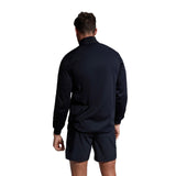 Rear view of a man wearing a Canterbury Elite Windstopper Jacket and black shorts, standing against a plain background.