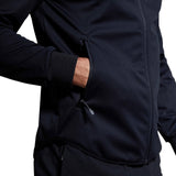 Close-up of a man wearing a Canterbury Elite Windstopper Jacket, showing a side pocket with his hand partially inserted.