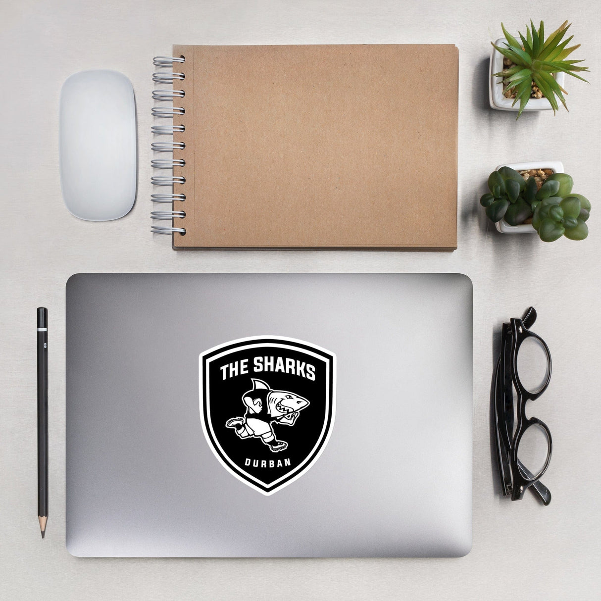 A durable vinyl PF LIC Sharks Crest Sticker proudly adorns a laptop, showcasing one's support for the South Africa rugby team.