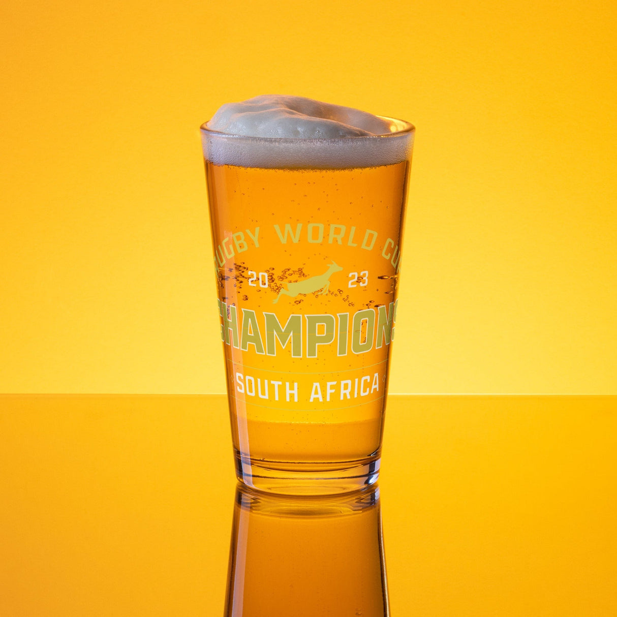 A PF LIC pint glass with the words "Champion South Africa" on it, commemorating their victory as RWC 23 Champions.