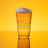 A PF LIC pint glass with the words "Champion South Africa" on it, commemorating their victory as RWC 23 Champions.