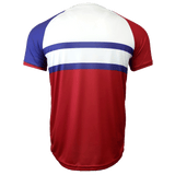 Back side of the round neck short sleeve United States jersey. White upper back, red right shoulder and sleeve with blue shoulder and sleeve trimmed in red. Two blue horizontal stripes run across the mid section with a red lower torso.