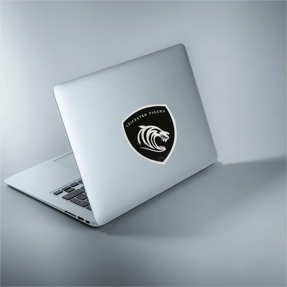 a laptop with a Leicester Tigers Sticker Sheet - 26 Stickers from World Rugby Shop on the screen.