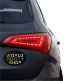 Rear view of a dark gray car featuring led taillights and a "World Rugby Shop Sticker Sheet - 19 Stickers", isolated on a green background.