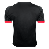 The Māori All Blacks Home Supporters Jersey by adidas is made from recycled polyester and showcases a black design with red cuffs and white accents on the shoulders, shown from the back.