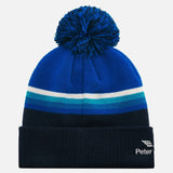 Royal and navy knitted pull on hat with pom pom atop, white and multi blue stripes through the middle with white Peter Hardy embroidered on cuff. 