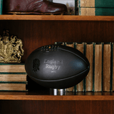 Gilbert England 1871 Vintage Leather Ball on a bookshelf.