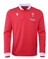 The Wales Long Sleeve Home Polo 22/23 by Macron is a red, long-sleeve sports jersey that features a white collar and cuffs. The jersey showcases a logo with a white feather emblem and the "WRU" letters, as well as the "CAZOO" brand mark on the left chest.