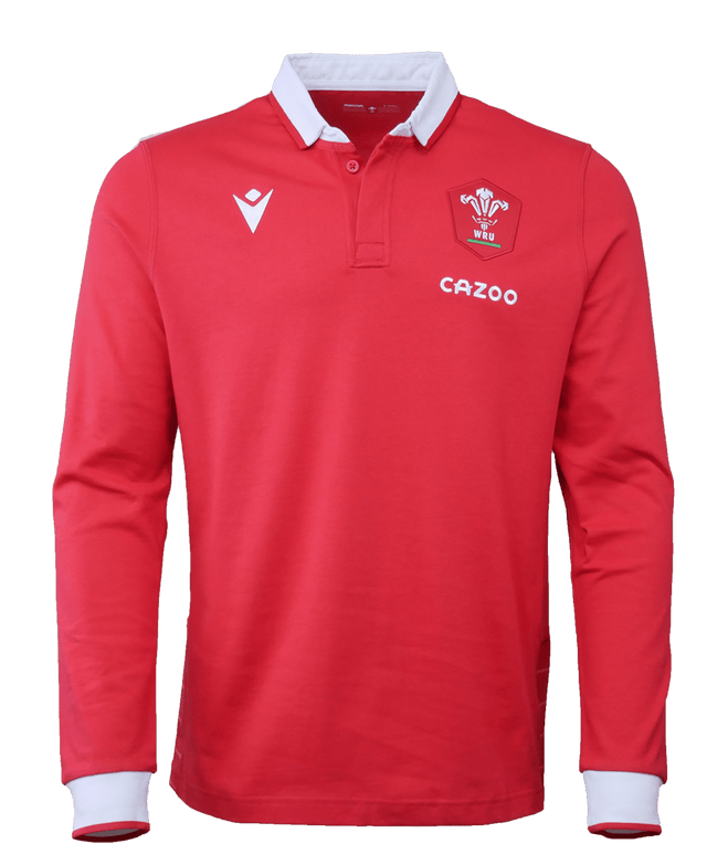 The Wales Long Sleeve Home Polo 22/23 by Macron is a red, long-sleeve sports jersey that features a white collar and cuffs. The jersey showcases a logo with a white feather emblem and the "WRU" letters, as well as the "CAZOO" brand mark on the left chest.