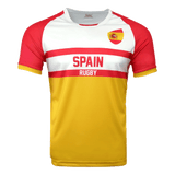 White round neck short sleeve jersey with red shoulders and arm sleeves trimmed in red. Flag of Spain on upper left shoulder, red stripes in the center with Spain in red and Rugby below in white in the red stripe. Torso is yellow.