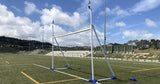 A Packaworld portable rugby post replacement crossbar on a soccer field with a sky background.