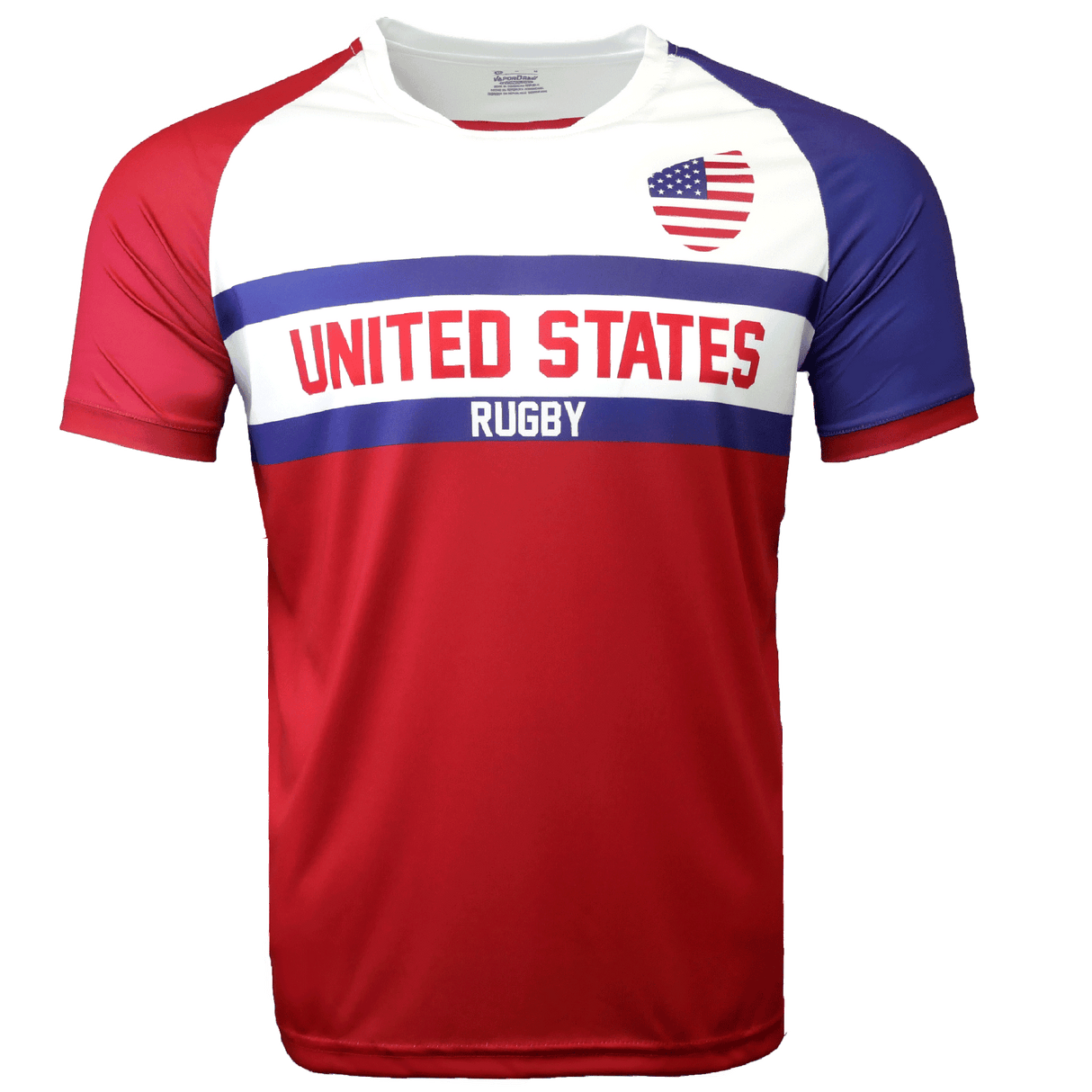 Round neck short sleeve jersey with white chest and upper left American flag in corner. Red right shoulder and sleeve and blue left shoulder and sleeve trimmed in red. Two horizontal blue stripes run across the chest. United States centered in red on the white jersey with Rugby in white on the blue stripe. The lower torso is red.