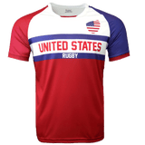 Round neck short sleeve jersey with white chest and upper left American flag in corner. Red right shoulder and sleeve and blue left shoulder and sleeve trimmed in red. Two horizontal blue stripes run across the chest. United States centered in red on the white jersey with Rugby in white on the blue stripe. The lower torso is red.