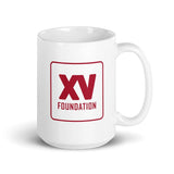 Sentence: a white XV Foundation Mug with a red logo on it.