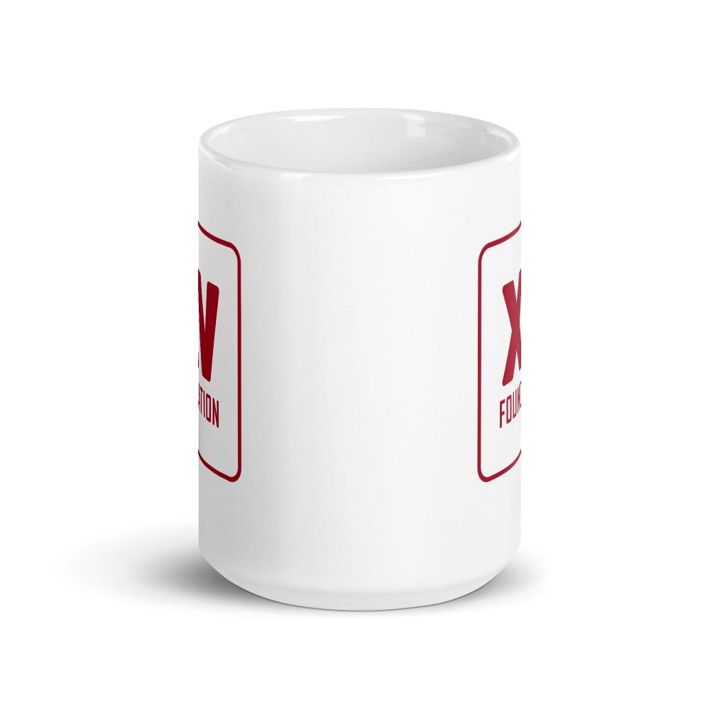 A white XV Foundation Mug with a red x on it.