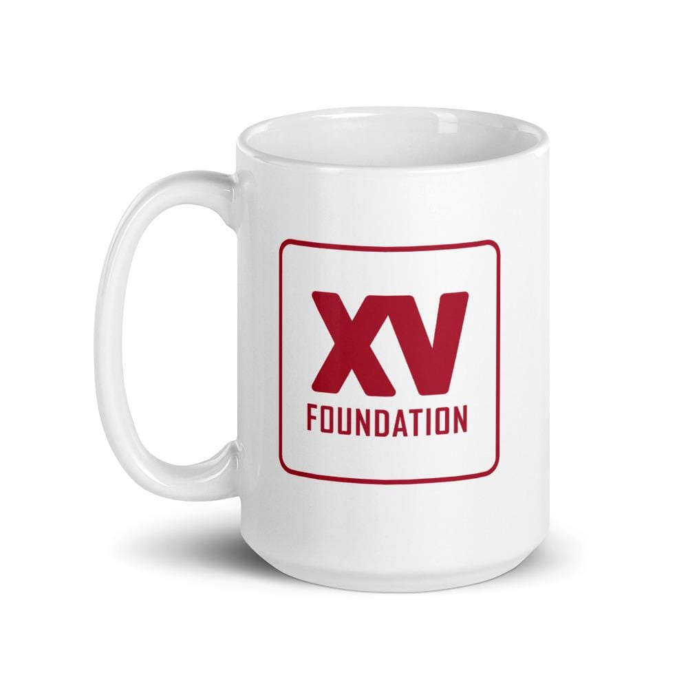 A white XV Foundation Mug with a red logo on it.