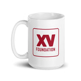 A white XV Foundation Mug with a red logo on it.