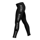 PF LIC's Women's Rugby Leggings, in black, are made from a polyester/spandex blend and feature "RUGBY" printed in white along the side. With their four-way stretch, they provide both style and comfort.