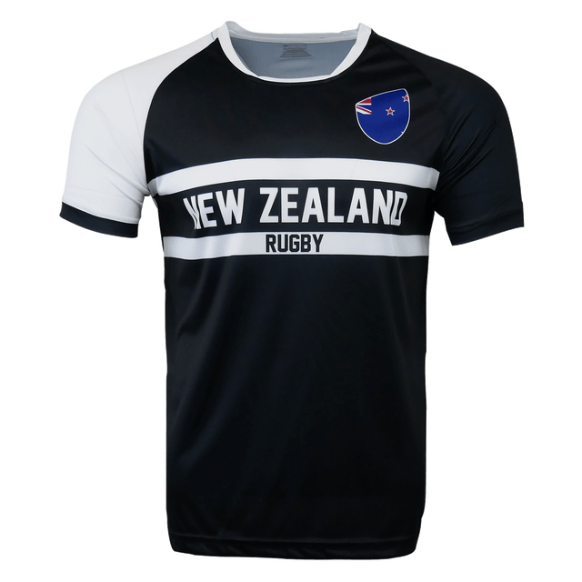 Round neck short sleeve jersey. White right shoulder trimmed in black. Chest and right shoulder in black. Two white center stripes with New Zealand in the center and Rugby below. The New Zealand flag sits on the upper left chest.