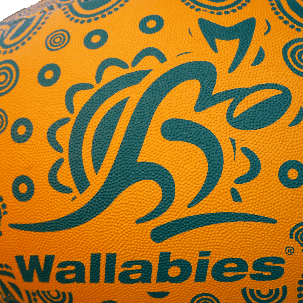 Detail shot of Wallabies logo on orange rugby ball.