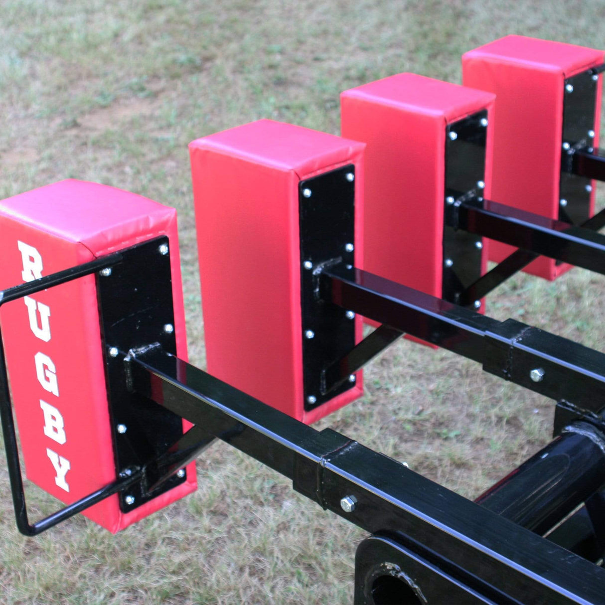 Close Up View of 4 Red Foam Pads Attached to Black Steel Scrum Sled